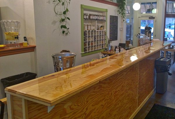 A long, thin wooden epoxy bar top.