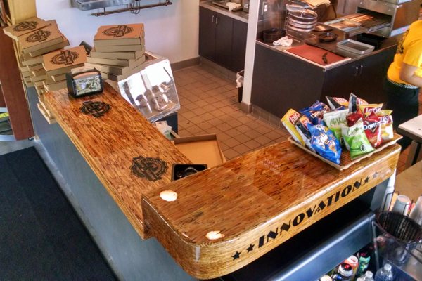 A large wooden epoxy bar top at a restaurant.