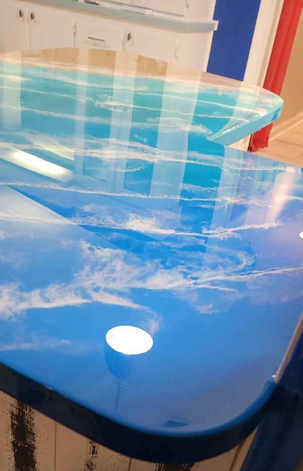 A beach-themed epoxy bar top made using epoxy powder pigments.