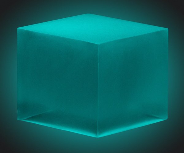 An epoxy cube made with Blue-Green Glow in the Dark Epoxy Pigment from Pigmently.