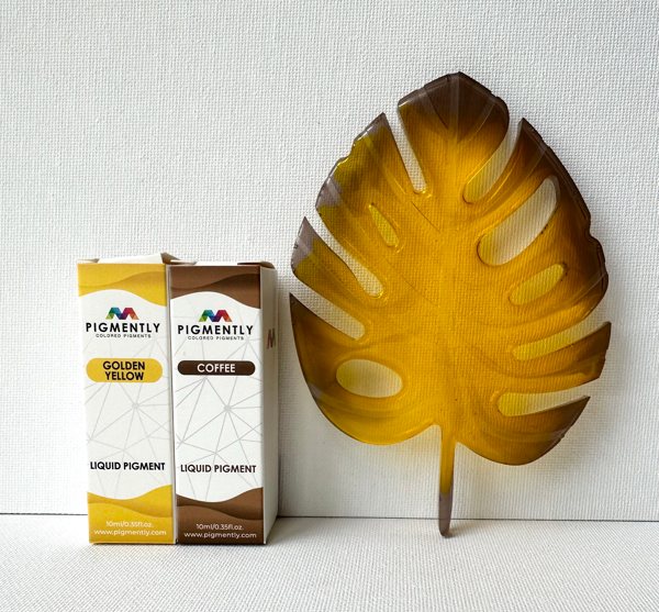 A resin art piece shaped like a leaf, made with Primaloc Epoxy Resin and colored with two liquid pigments from Pigmently.
