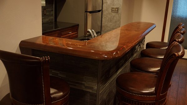An indoor wooden epoxy bar top with an exceptionally well-poured resin coating.