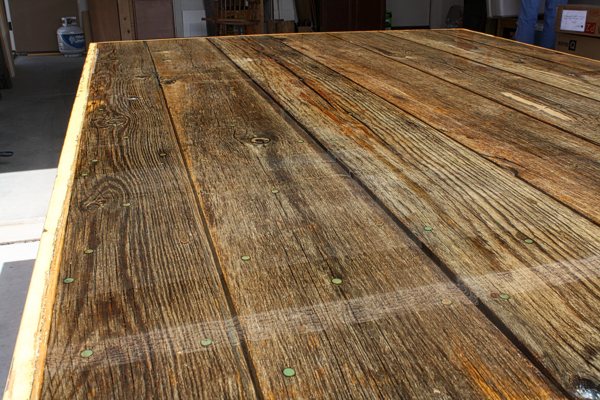 A wooden epoxy resin table top that had a seal coat applied, before a properly-mixed flood coat to mitigate air bubble formation.