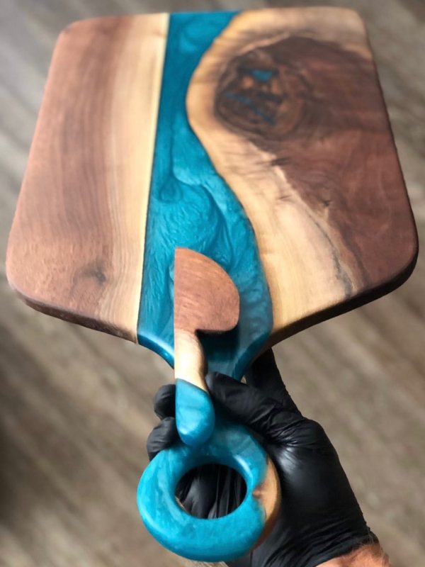A finely sanded down wooden epoxy charcuterie board.