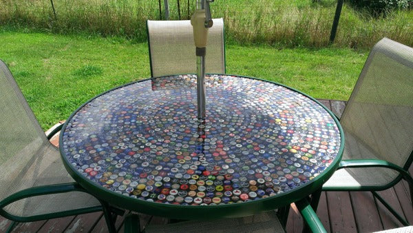 An outdoor epoxy resin table with a table umbrella to shelter it from direct sunlight.