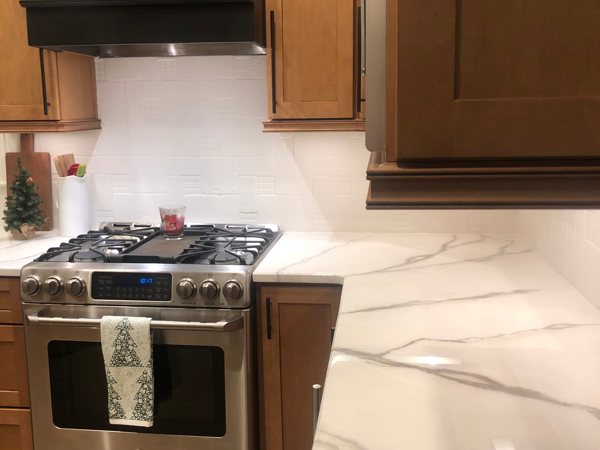 An epoxy kitchen countertop with a marble-like pattern made using epoxy powder pigments.