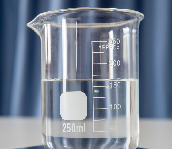 A measuring cup partially filled with resin.