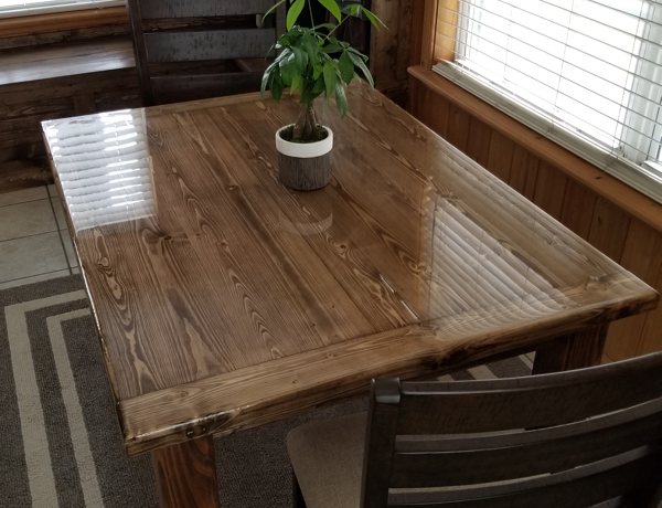 A dark brown wooden table with an epoxy resin finish.
