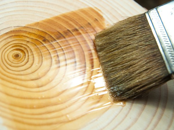 Tung oil being applied to a wooden surface.