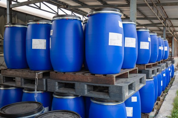 A photo of many blue barrels stacked near each other.