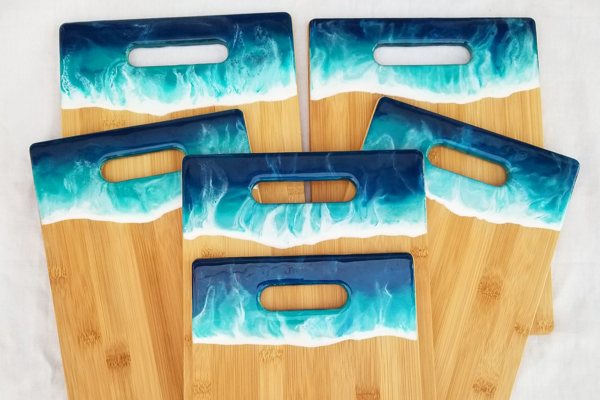A set of cutting boards with tinted epoxy resin accents.
