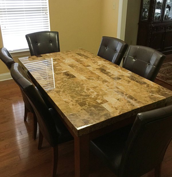 An epoxy table top surrounded by chairs.