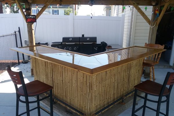 An outdoor epoxy bar top with a wooden shelter.