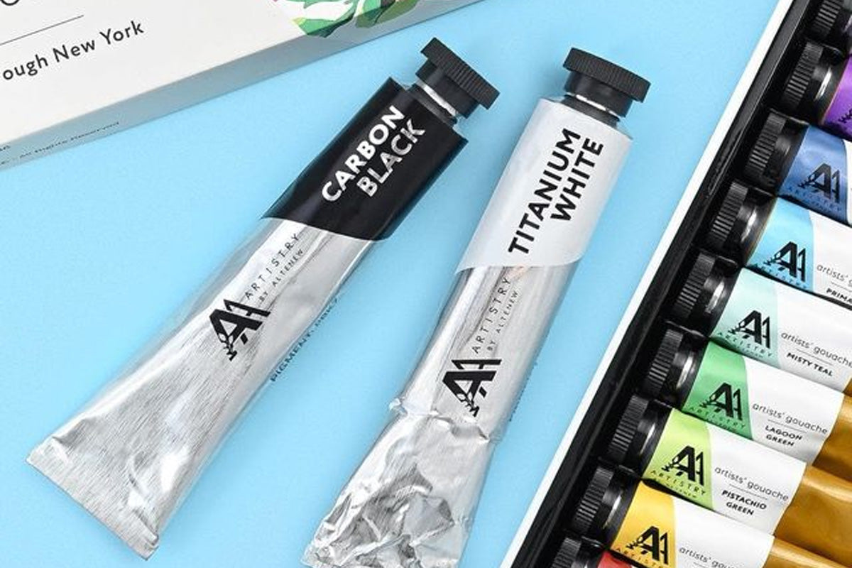 Carbon Black and Titanium White gouache tubes, alongside Artistry by Altenew's Artists' Gouache: Strolling Through New York