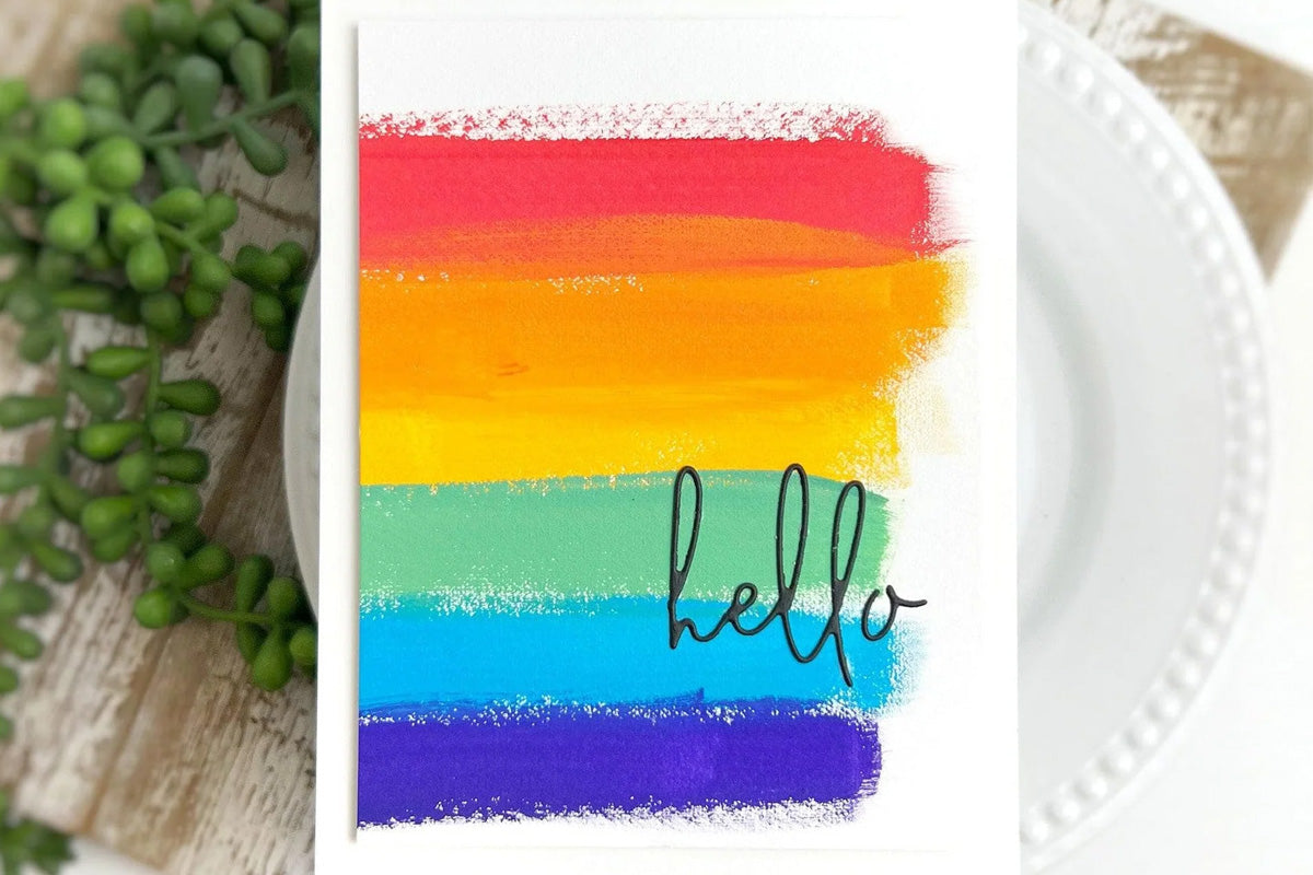 A greeting card with rainbow stripes in the background, created with Artistry by Altenew's gouache paint set