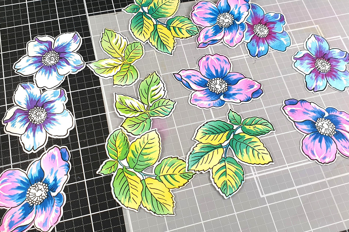 Die cuts of different flowers and leaves with various colorful ink layers and blends
