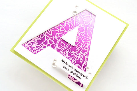 A monogram card with a purple monochrome ink resist design