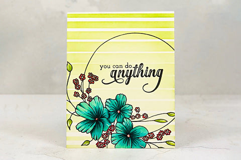 An encouraging card with a yellow striped background and a teal blooms in the foreground