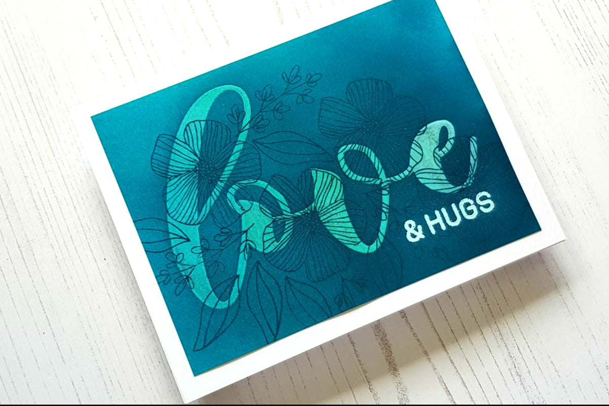 A "love and hugs" card created with the ink resist technique and ink blending brushes