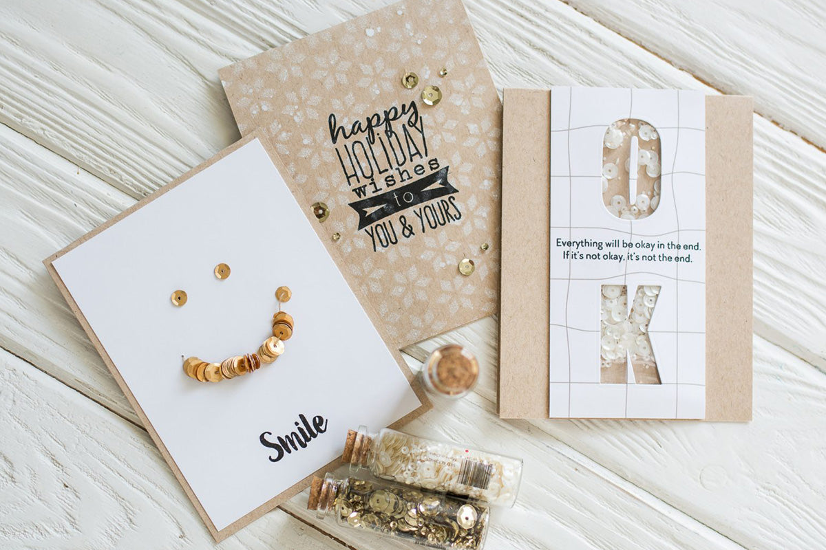 3 neutral colored handmade greeting cards decorated with gold and white sequins