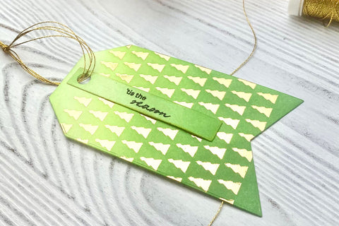 DIY holiday gift tag with gold embossed design and a gold metallic thread