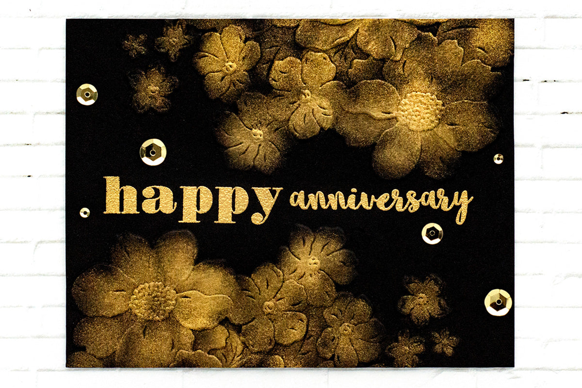 Black and gold anniversary card with gold embossed flowers and gold sequins