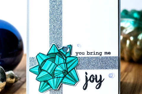 Handmade holiday card with a bow and glitter tape
