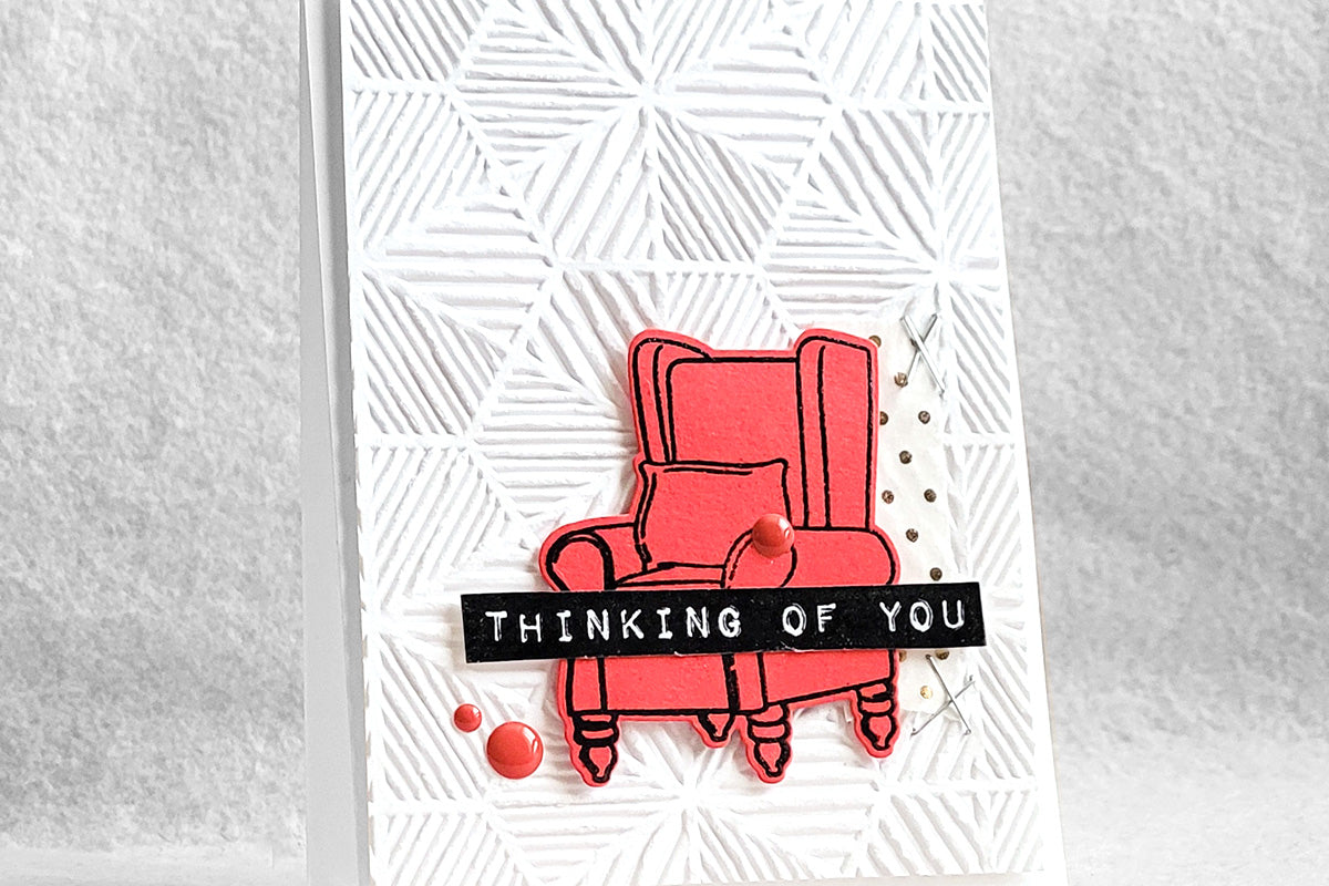 CAS card with a 3D geometric embossed background and a red armchair image