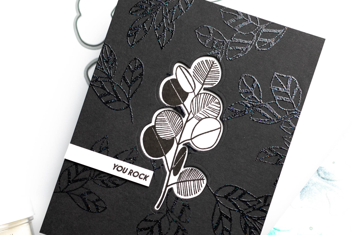 A beautiful tone-on-tone black card with a black and white foliage as its focal point 