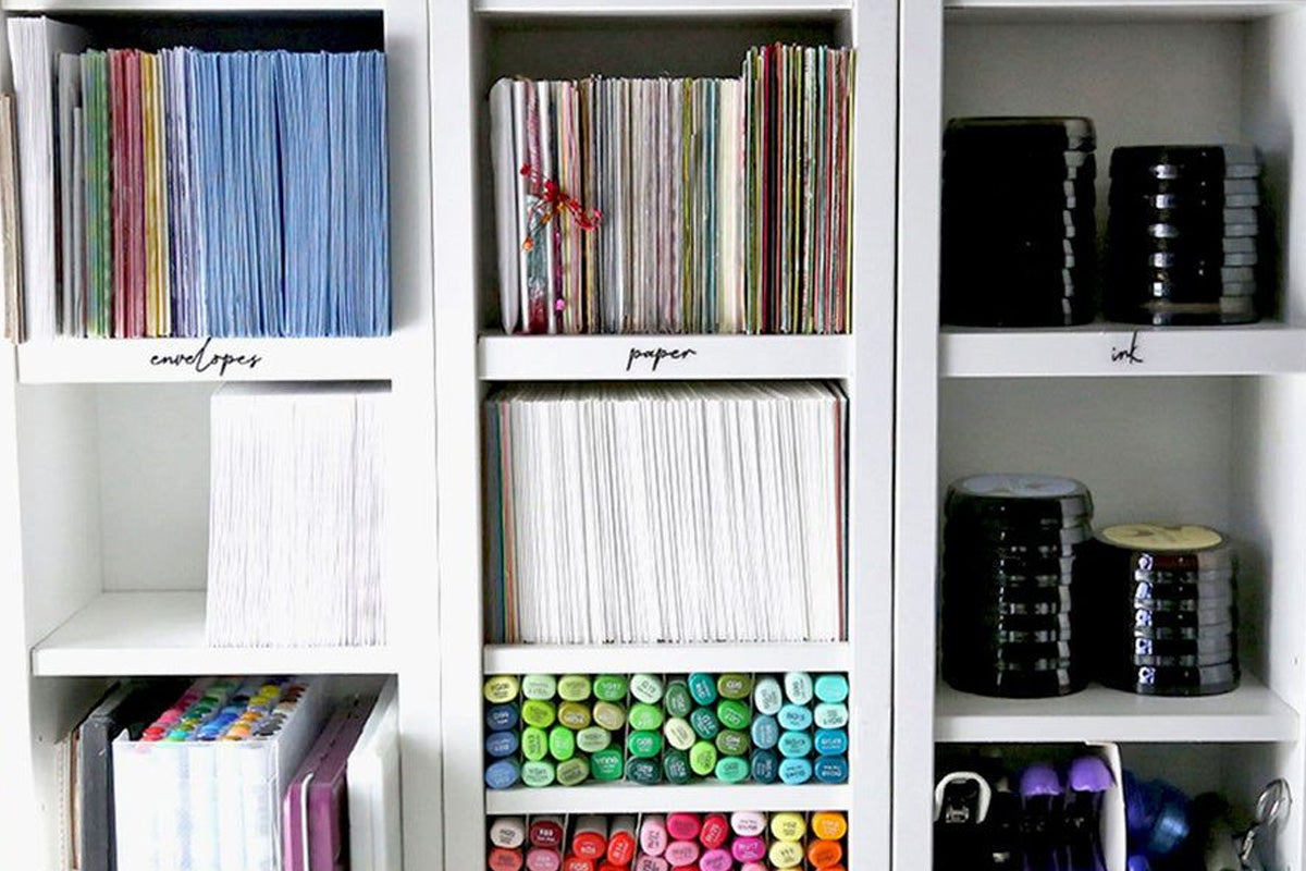 An organized crafting space filled with stamps, cardstock, markers, and inks