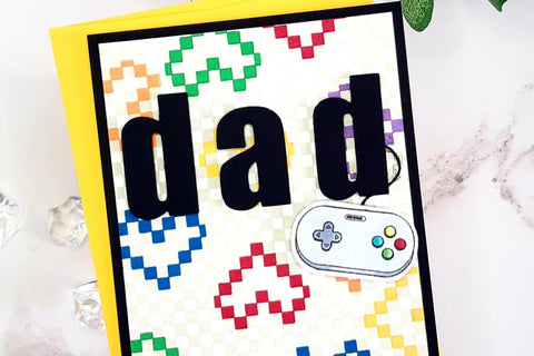 Cool Father's Day 2024 card idea with stamped colorful hearts in the background, a PSP controller and the word "dad"