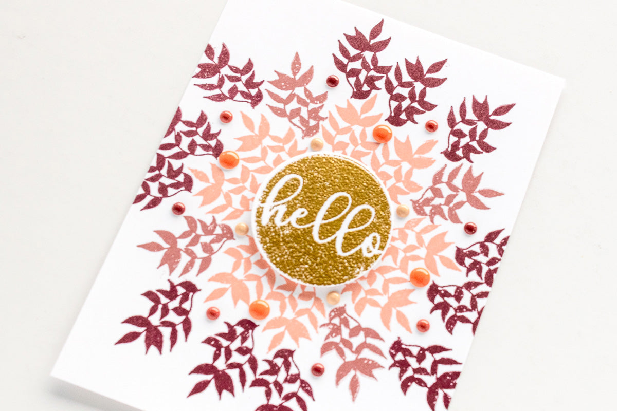 A DIY greeting card with a wreath design and color coordinating enamel dots