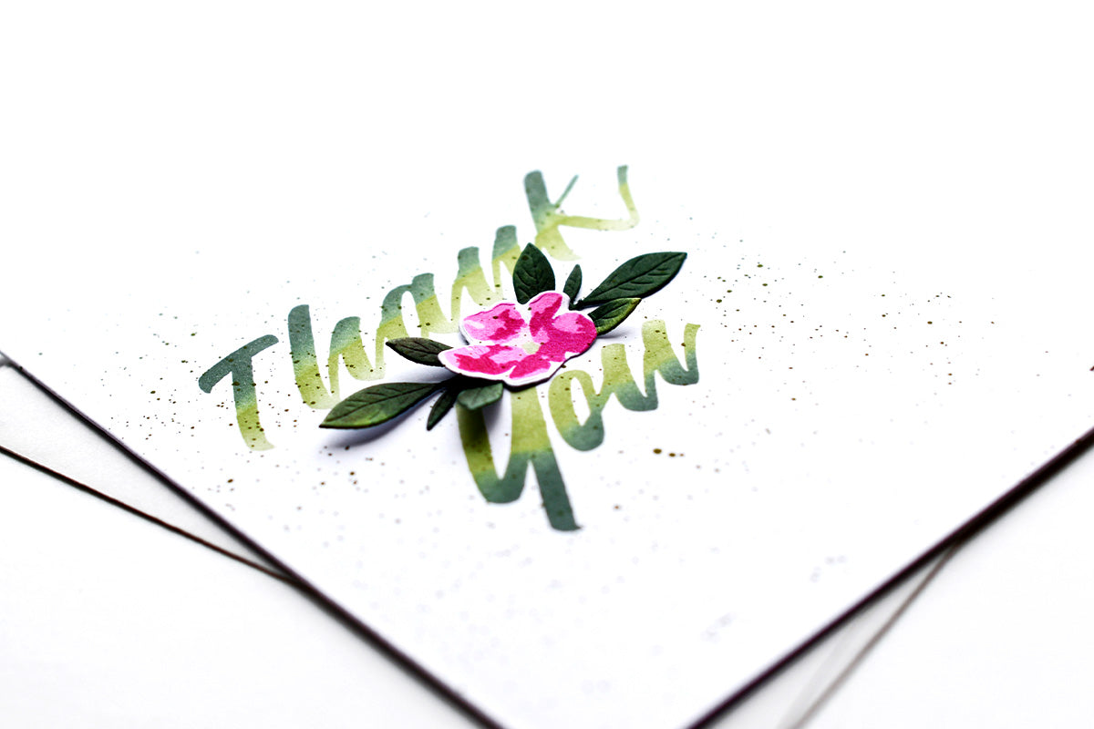 Clean and simple thank you card with a pink flower die-cut in the middle