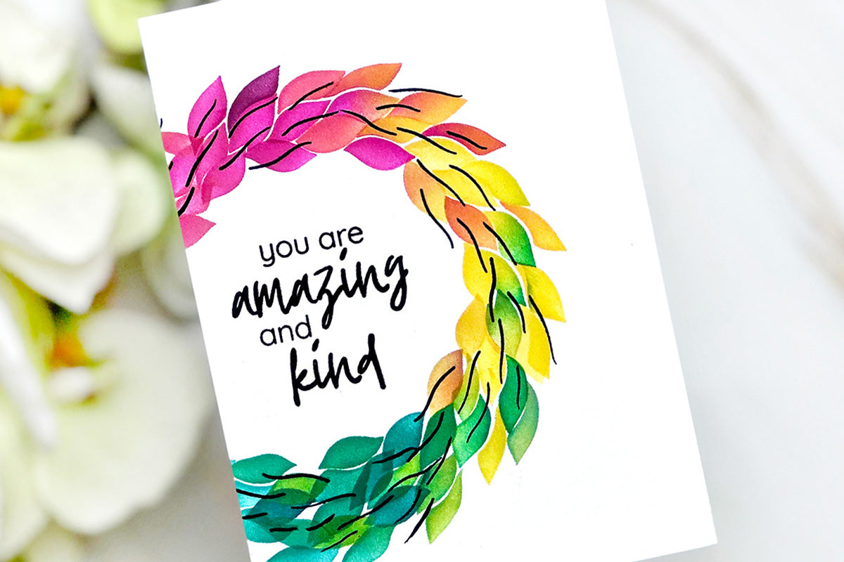 Easy handmade card idea with a rainbow wreath and encouraging sentiment stamped in the middle