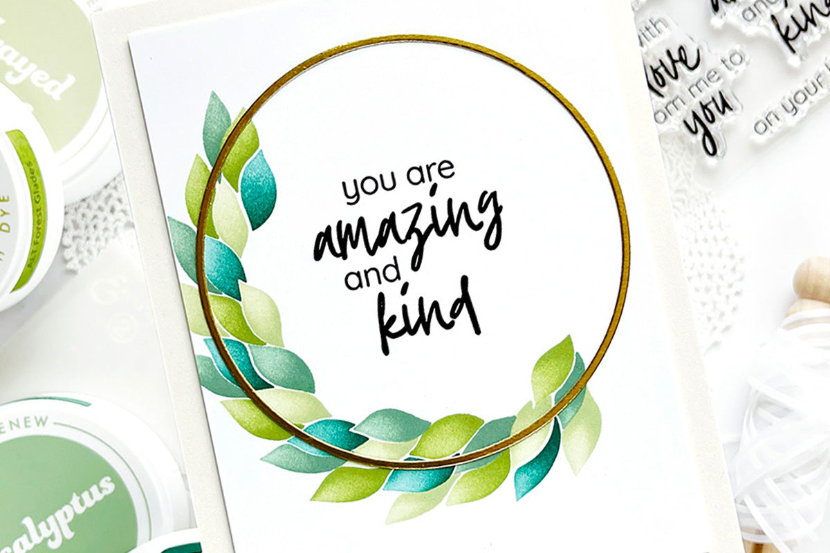 CAS card featuring a half wreath with a leaf design and the sentiment "you are amazing and kind" stamped in the middle