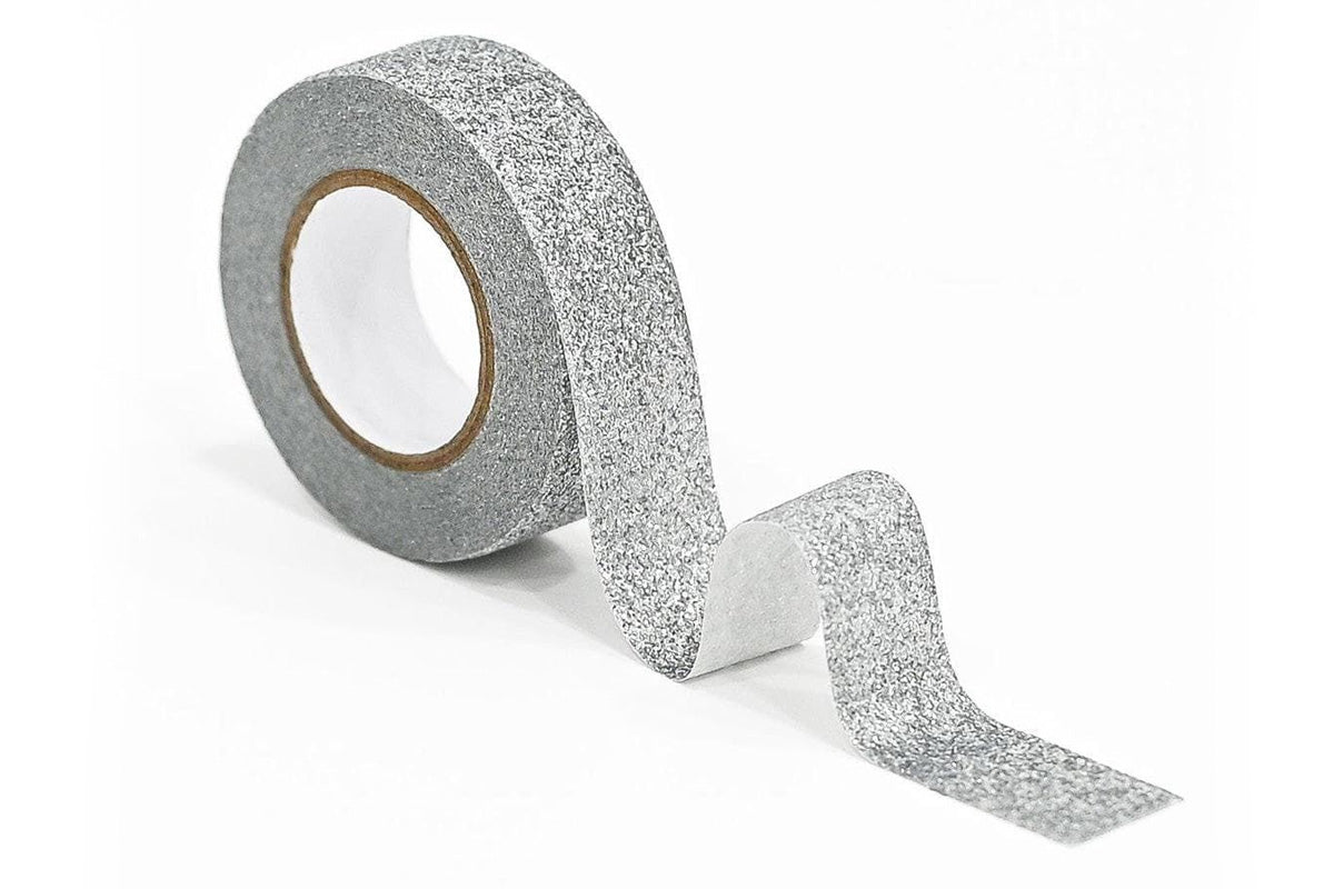 Altenew's Moonlit Silver Glitter Tape on its side, partially unfurled