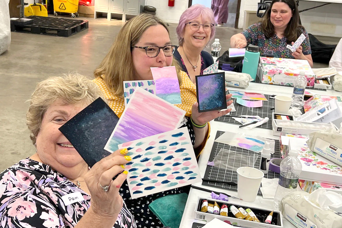 A group of crafters having fun and showing off their card creations