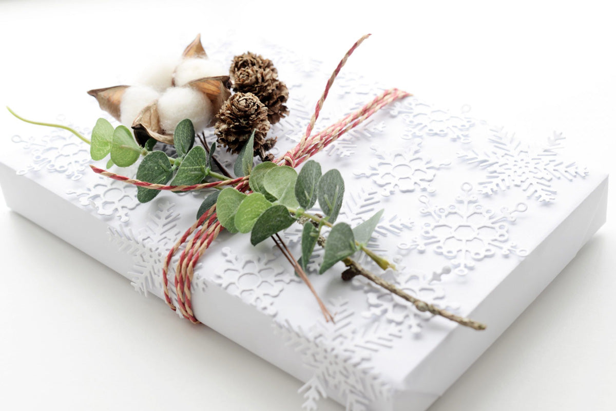 white gift wrapping decorated with 3D layered snowflake die-cuts
