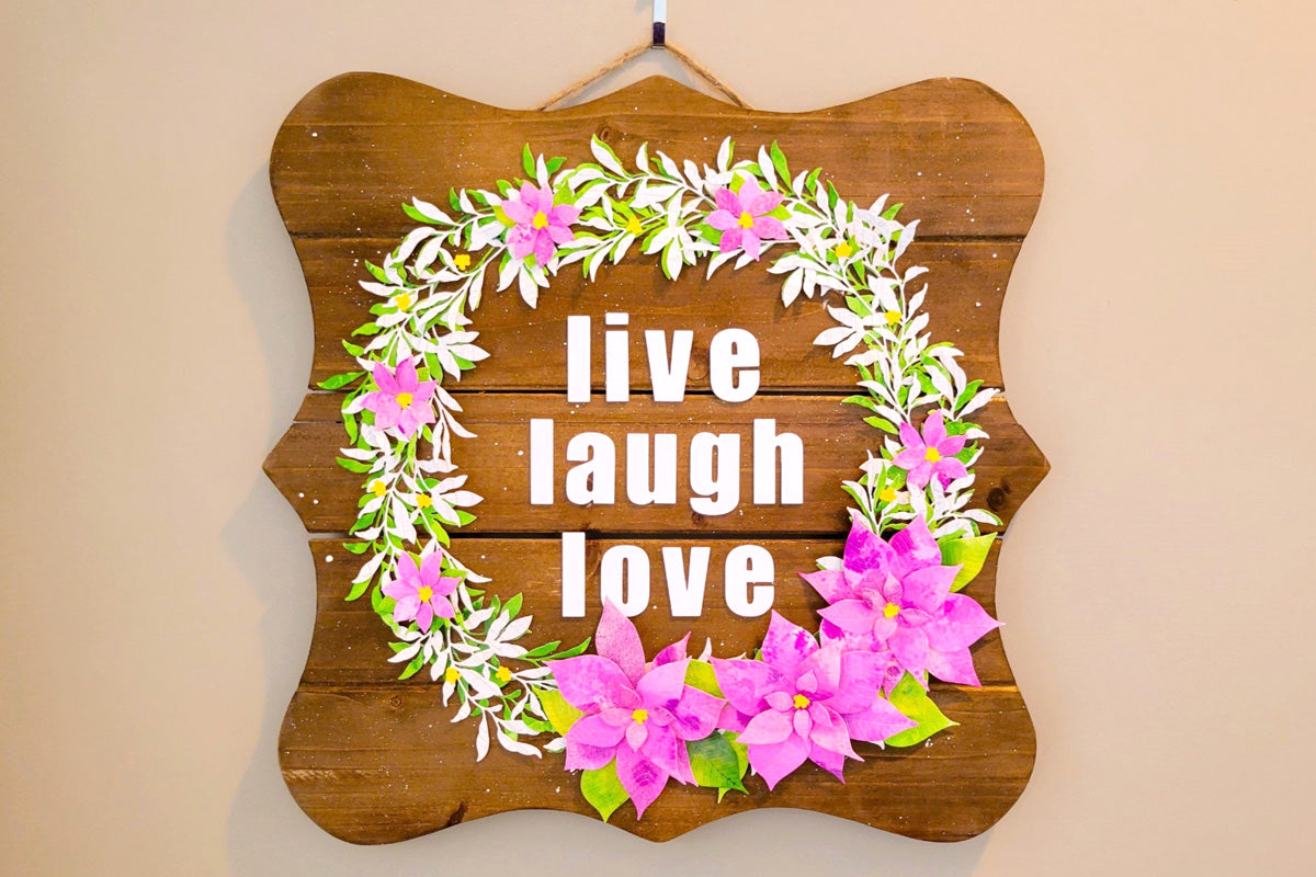 DIY wall plaque with 3D paper flowers and the words "live laugh love"