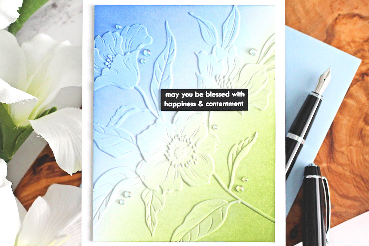 A gorgeously embossed card featuring blue and green crisp dye ink colors