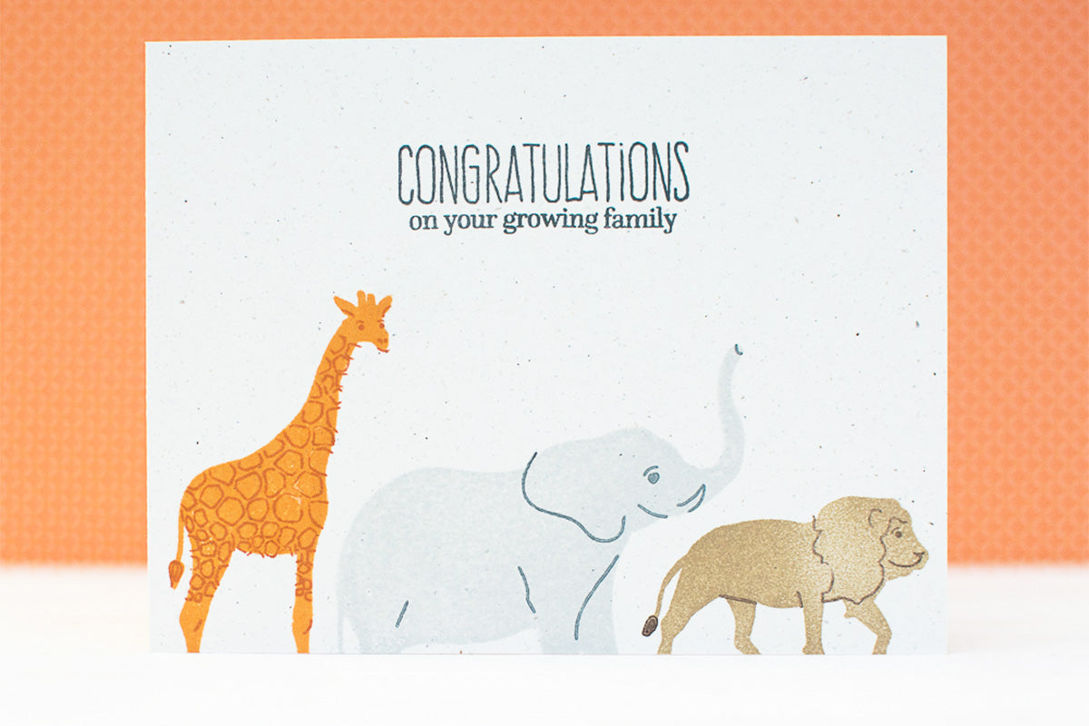 Cute baby shower card with stamped animals and a sentiment that says "congratulations on your growing family"