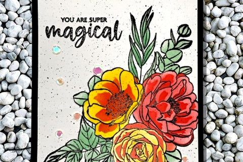 A "You are super magical" card with a floral bouquet as the focal point on a white background embellished with shiny sequins, enamel dots, and glitter