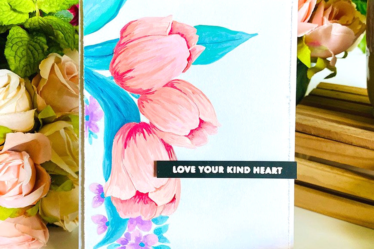 A beautiful card with tulips as the focal point on a subtle sky-blue background, with the words "love your kind heart"