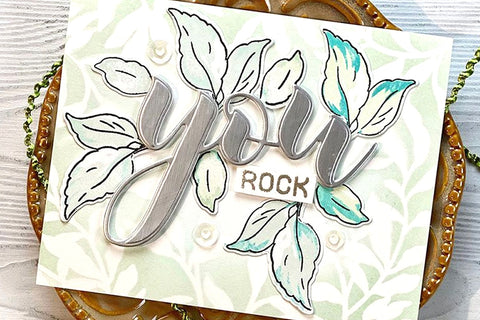 A silver embossed "You rock" sentiment on a leaf/nature-themed card