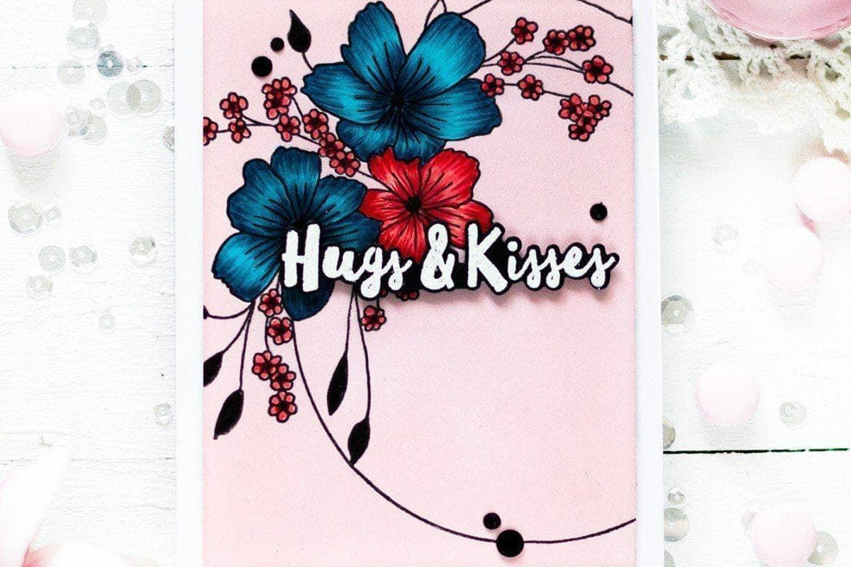 A "hugs and kisses" card with a pink background and a bunch of blue and red flowers, created with Altenew's pigment inks