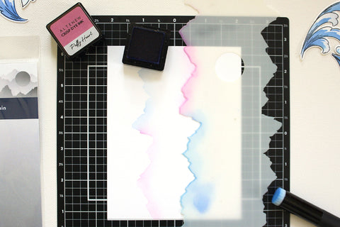 A process photo of adding stenciled images on a card panel