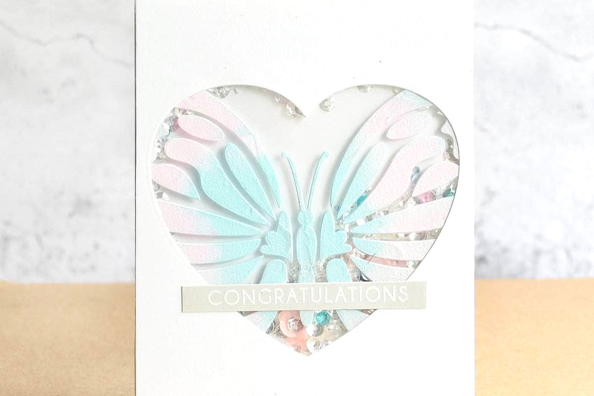 Heart window card with a stenciled and embossed butterfly, made with Altenew stencils and embossing paste