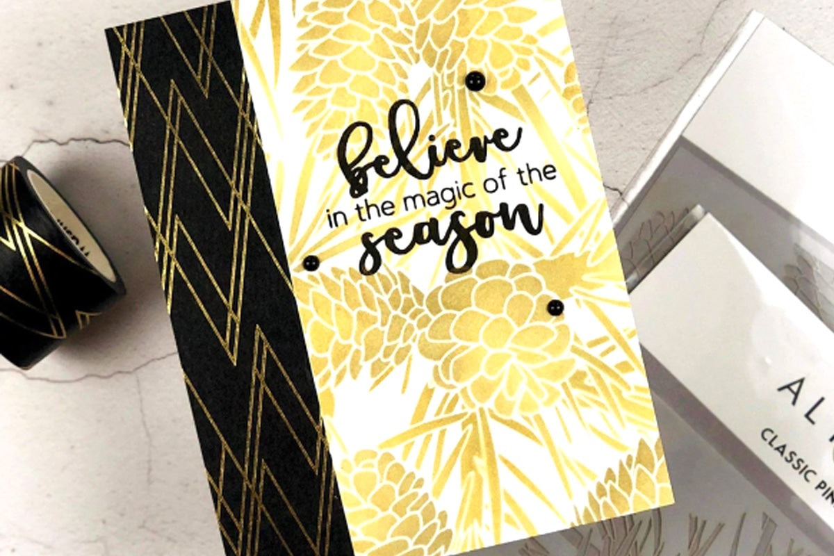 DIY Christmas card with stenciled pinecones and black and gold washi tape