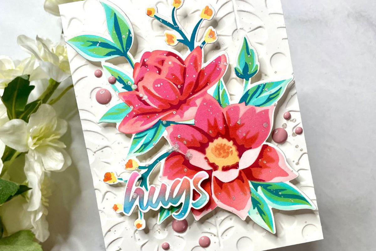 3D greeting card with red flower die-cuts, textured background, and the sentiment "hugs"