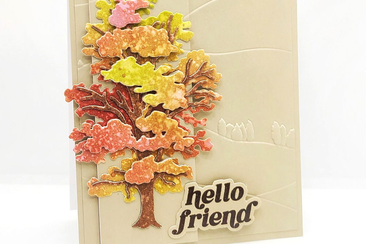 A friendship themed handmade card with a 3D chestnut pine tree made with layering dies